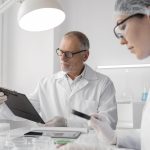 small labs team looking at sample and paperwork